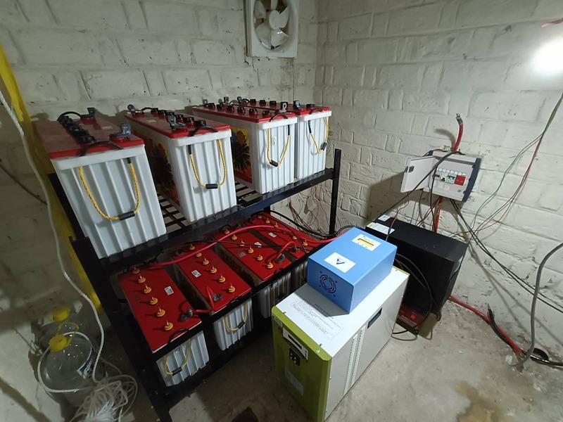 Photograph of battery room showing battery bank and inverters